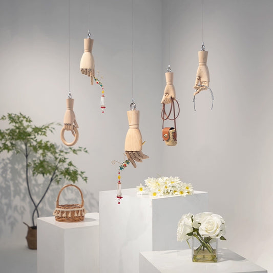 Wall mounted mannequin hand used as a creative accessory holder in a boutique store