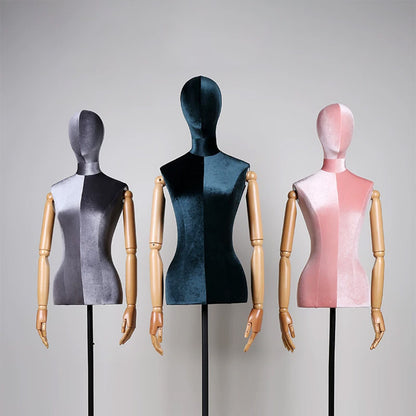 Two-tone velvet female mannequin torso with movable wooden arms and black triangle base for luxury fashion display.