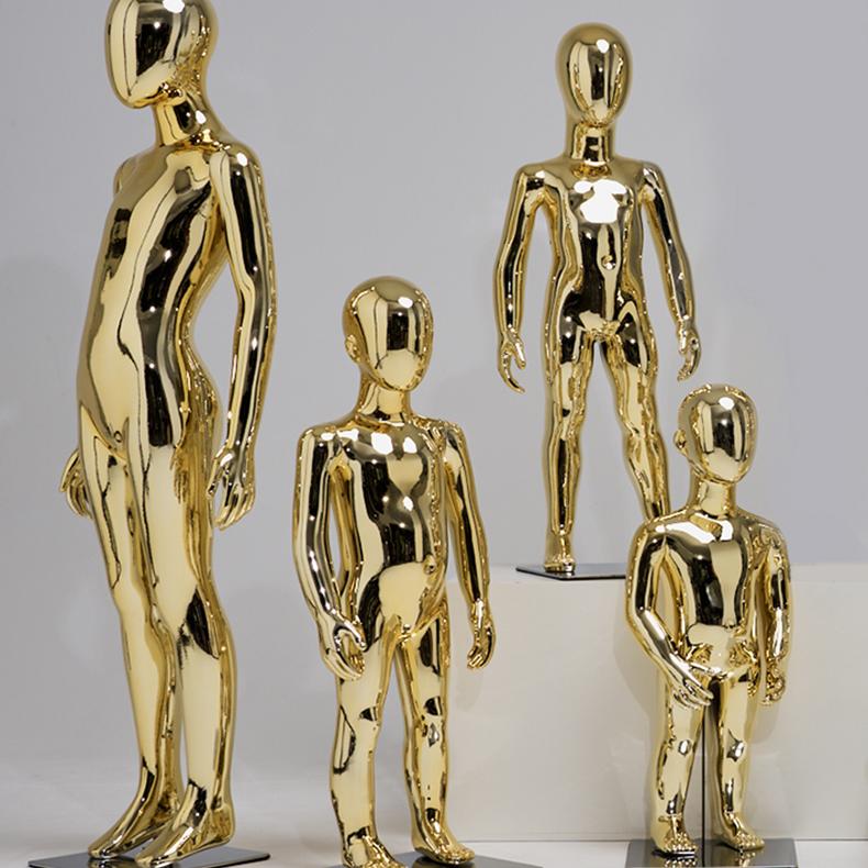 Gold child mannequin showing kids hoodie and pants in boutique display
