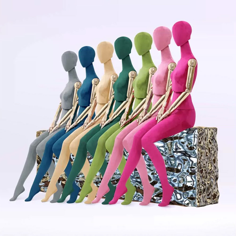 Sitting pose female mannequin with white chair and gold articulated arms for clothing store
