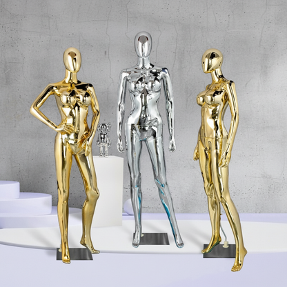 Three metallic mannequins with concrete background