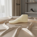 Wooden foot mannequin on silk fabric